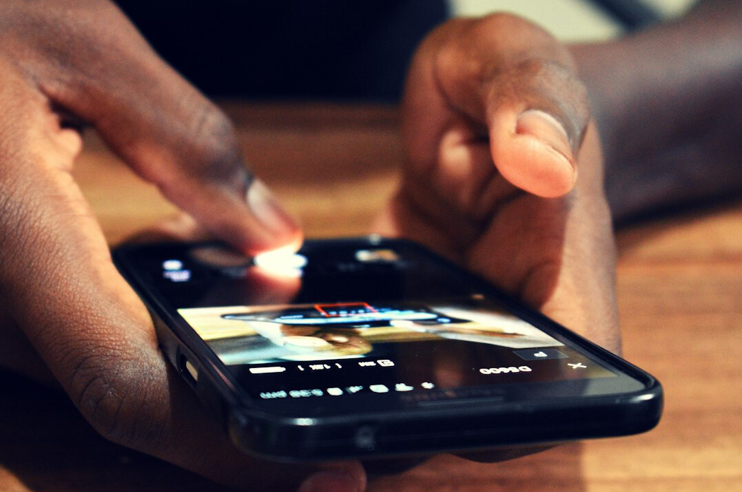 person scrolling on smartphone