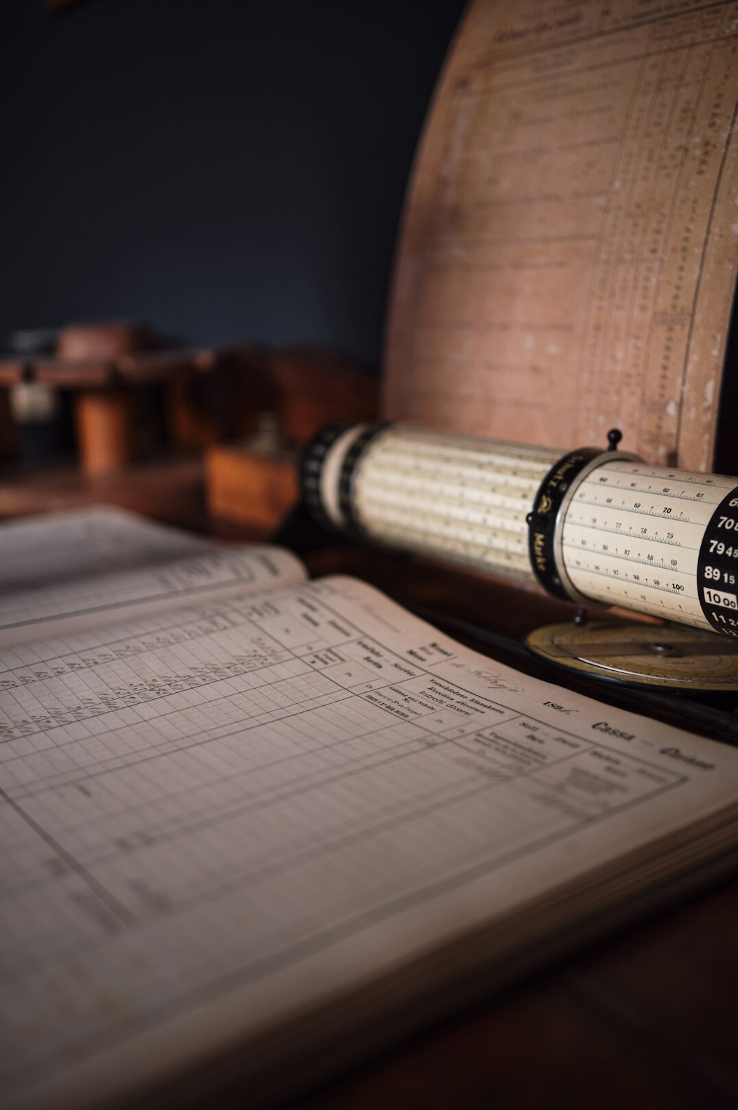 Close-up of archival research documents and handwritten notes on a wooden desk